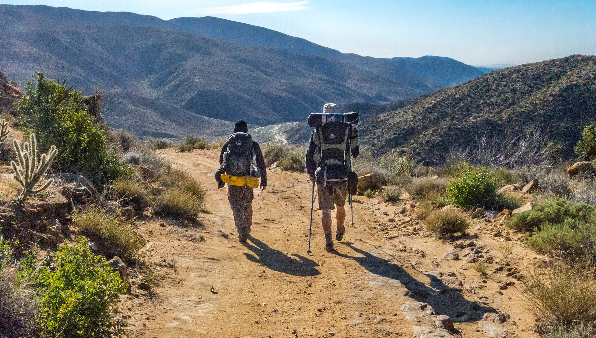 Two backpackers hike down the Juan Bautista de Anza National Historic Trail.
