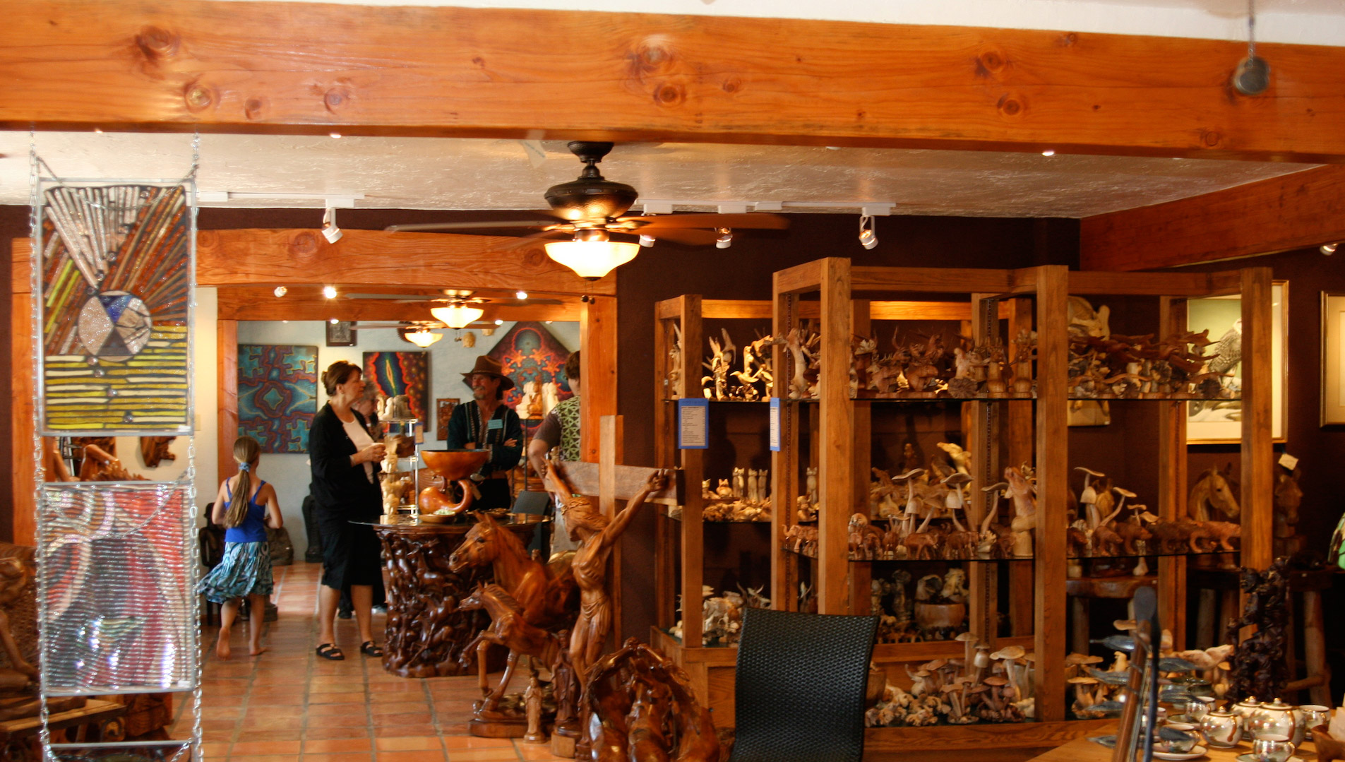Teak wood carvings line the shelves inside Sacred Treasures.